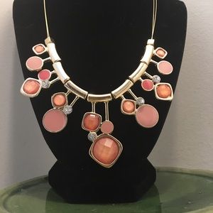 Gold toned and pink jewel statement necklace.
